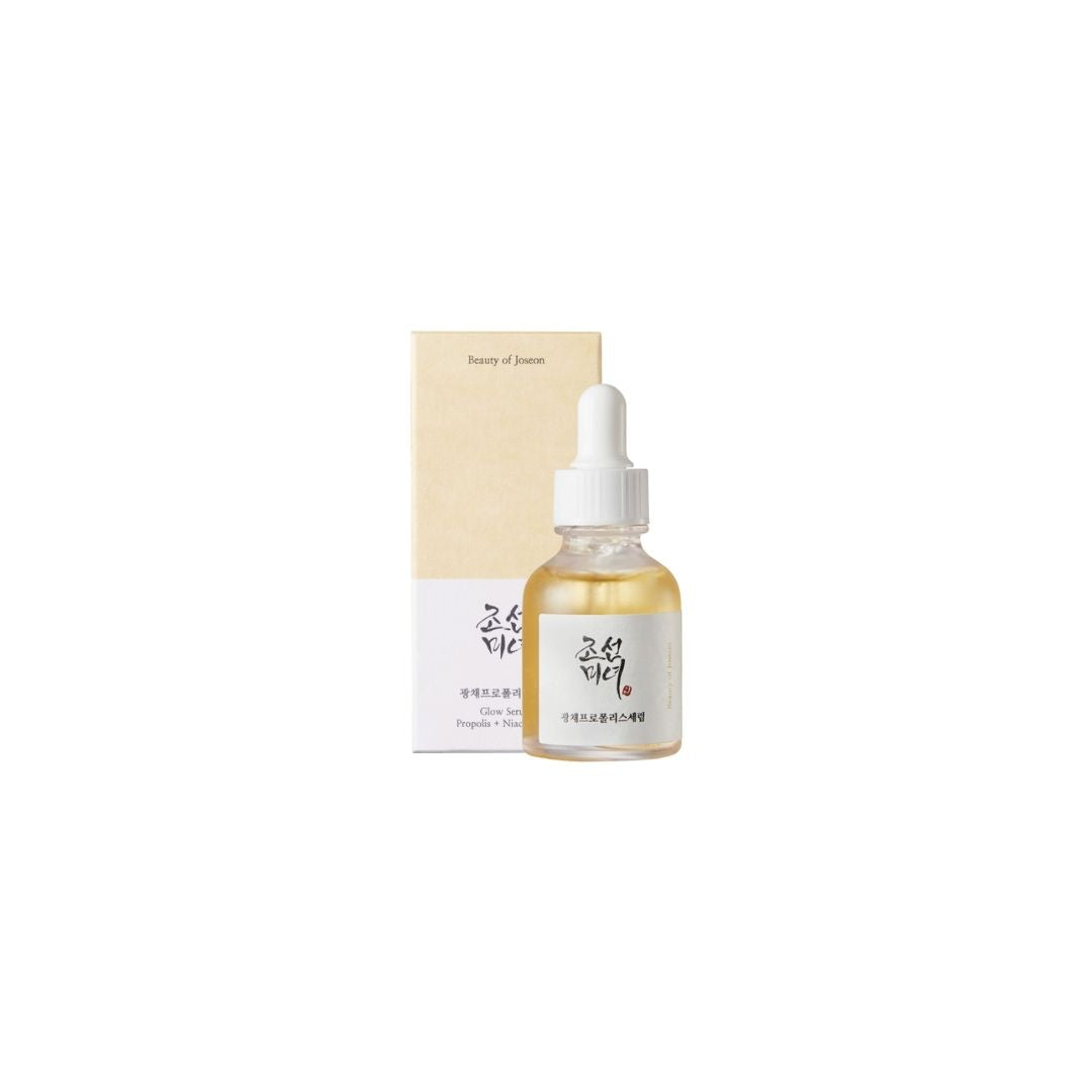 Beauty Of Joseon Glow Serum 30ml amber bottle with pipette on a marble surface, showcasing golden honey texture
