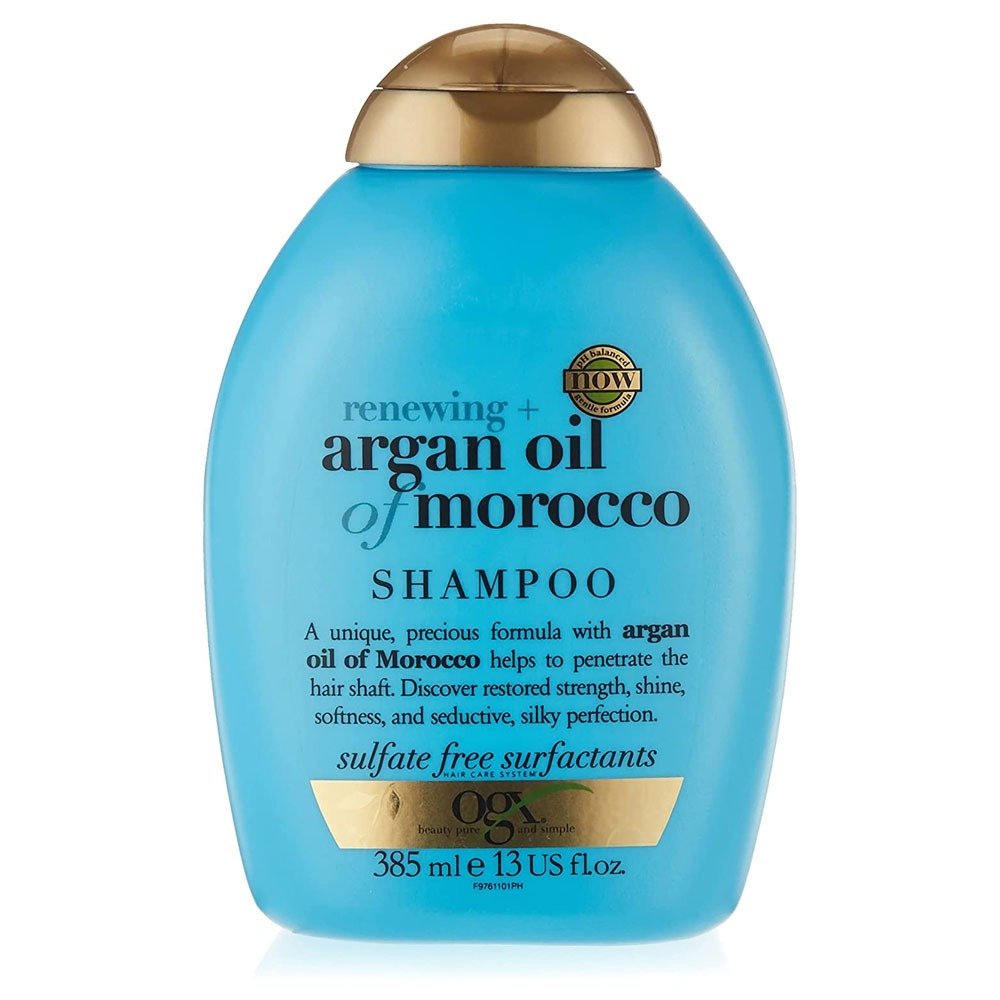 Ogx Renewing+ Argan Oil Of Morocco Shampoo 385ml bottle on a white marble surface, showing the product label and size