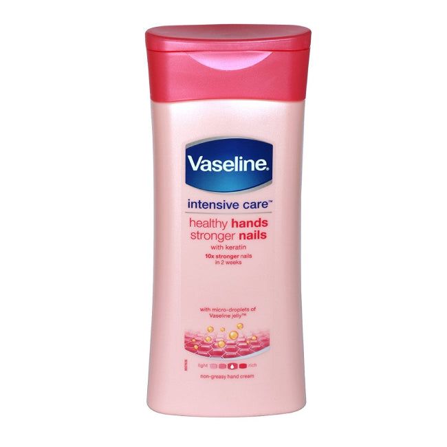 Hand applying a small amount of white hand lotion from Vaseline pump bottle