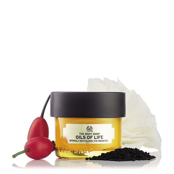 Close-up of The Body Shop Oils Of Life Intensely Revitalising Eye Cream Gel jar with gold lid and green packaging